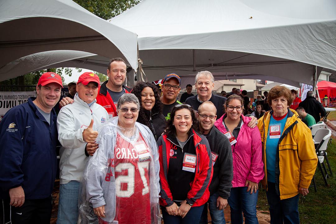 Group of SXU alumns at a homecoming tent